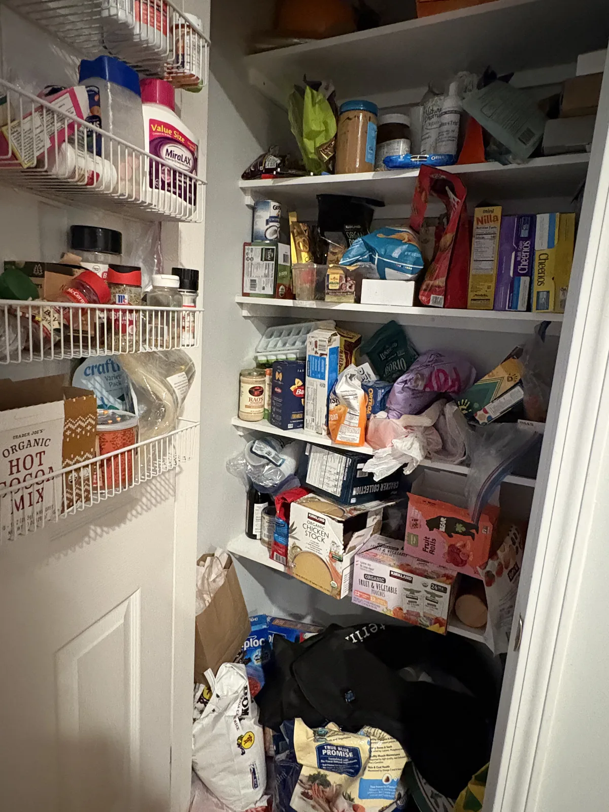 Before: pantry shelves overcrowded with loose bags and stacked boxes